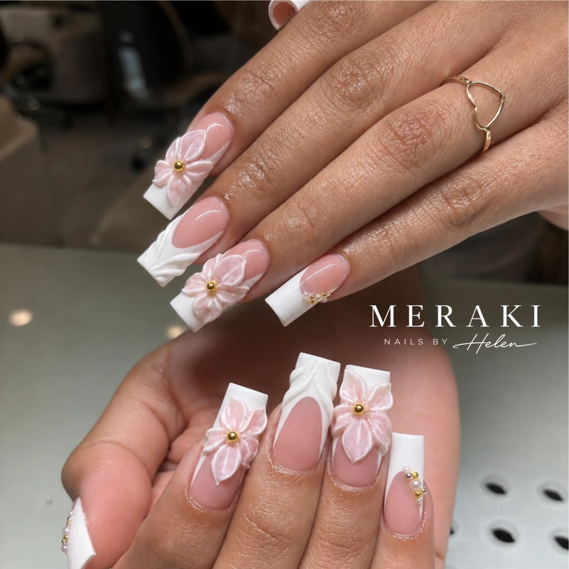 Long white French nails with 3D pink floral art and pearls